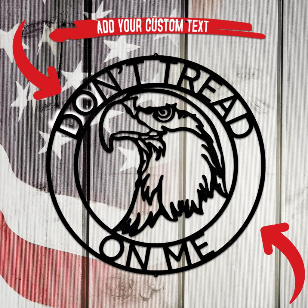 Black metal "Don't Tread On Me" eagle head ring monogram wall art on a rustic American flag background.