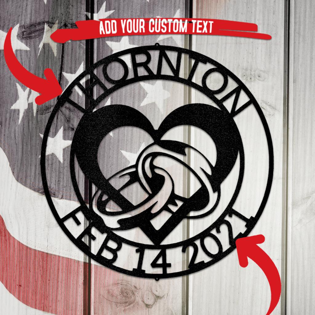 Black metal engagement heart and rings wall art with custom text "THORNTON FEB 14 2021" on a flag background.