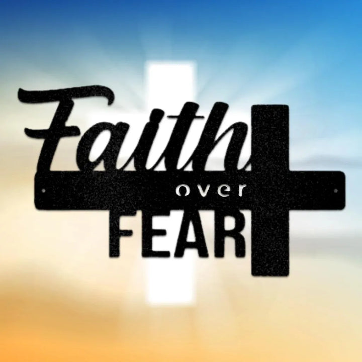 Black metal "Faith over Fear" wall art with a cross design, set against a blue and orange sky.