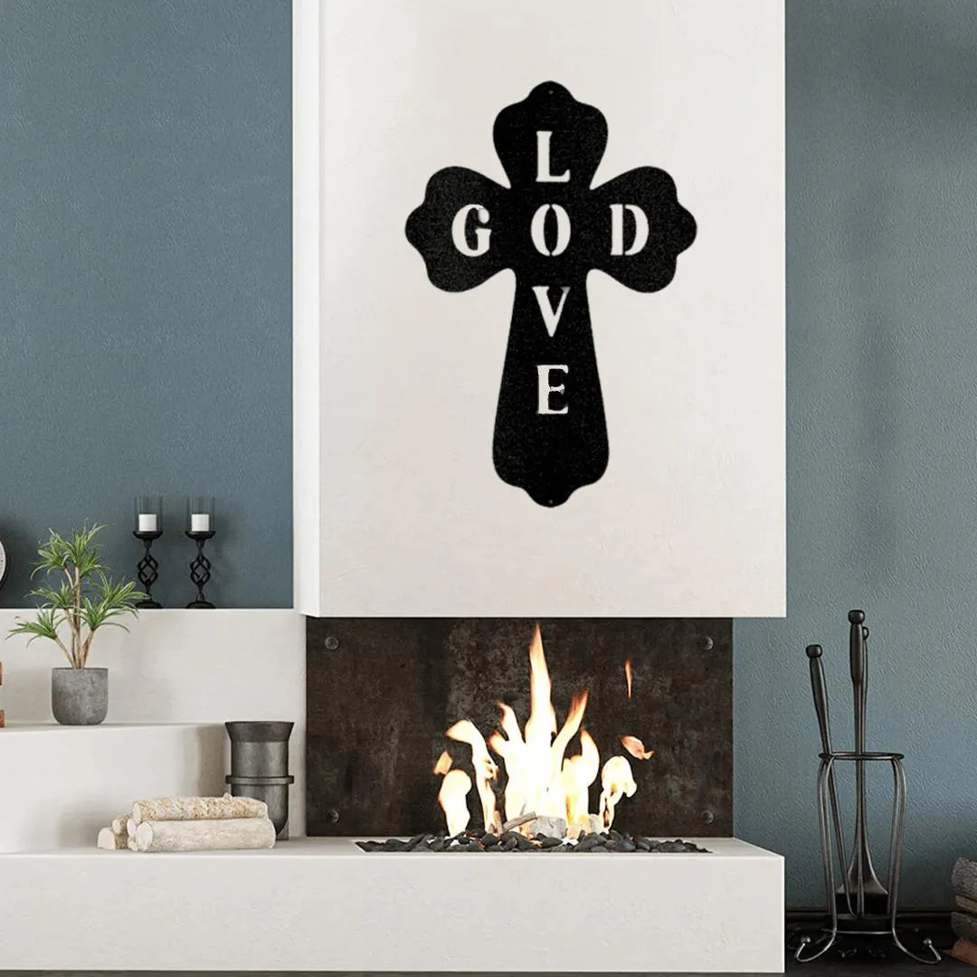 Black metal cross wall art with "GOD LOVE" text, mounted above a modern fireplace.