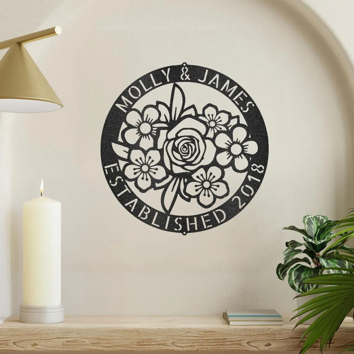 Black metal floral ring monogram wall art with "Molly & James Established 2018" text.
