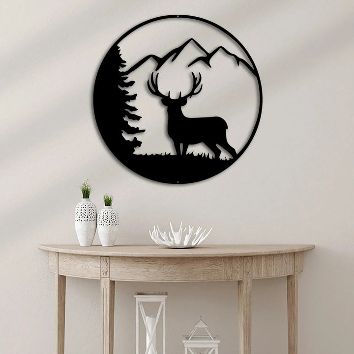 Black metal wall art: circular deer silhouette with mountains and pine tree.