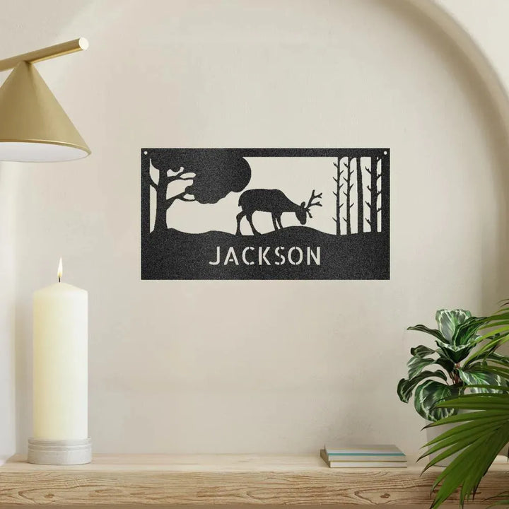 Black metal wall art featuring a grazing deer, trees, and "JACKSON" personalized text.