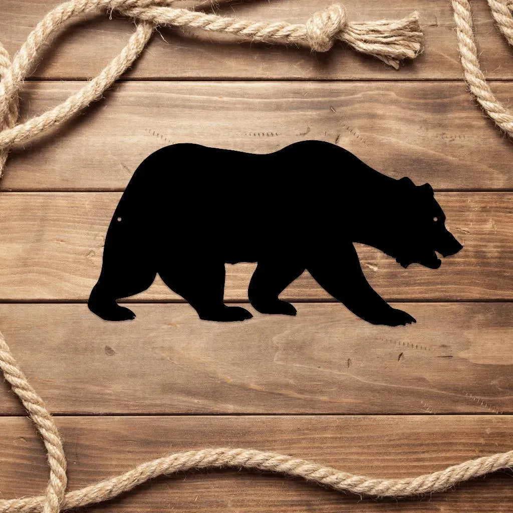 Black metal grizzly bear wall art silhouette on wood, framed by rope.