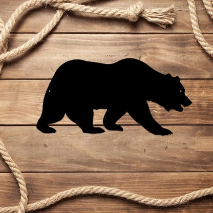 Black metal grizzly bear wall art silhouette on wood, framed by rope.