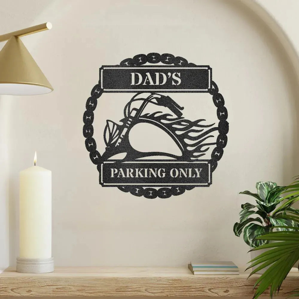 Black metal "Dad's Parking Only" wall art featuring a flaming motorcycle design, mounted on a light wall.