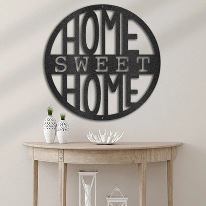 Black circular metal wall art with "HOME SWEET HOME" cutout, hanging above a wooden console table.