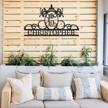 Black powder-coated metal wall art featuring a decorative initial "C" monogram above the name "CHRISTOPHER".