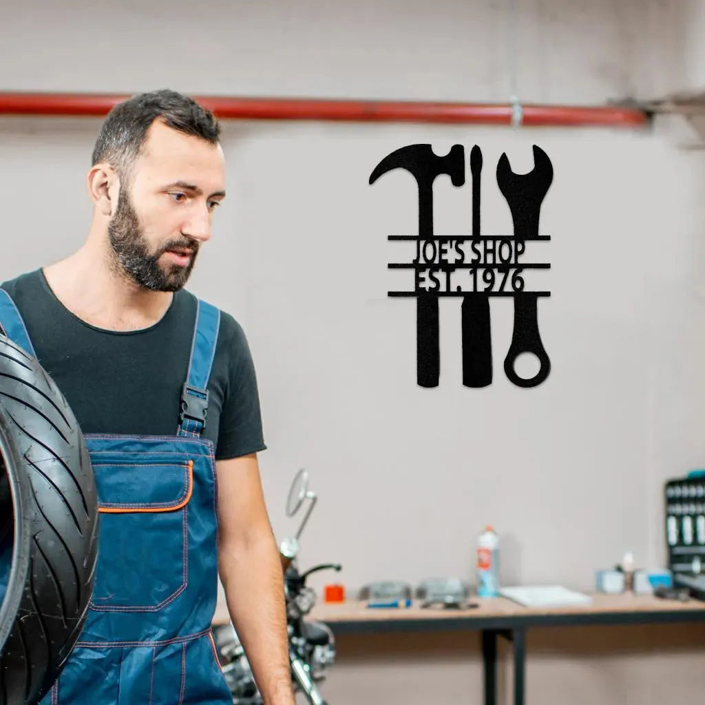 Black metal wall art with hammer, wrench, and tools, customized "Joe's Shop Est. 1976" text.
