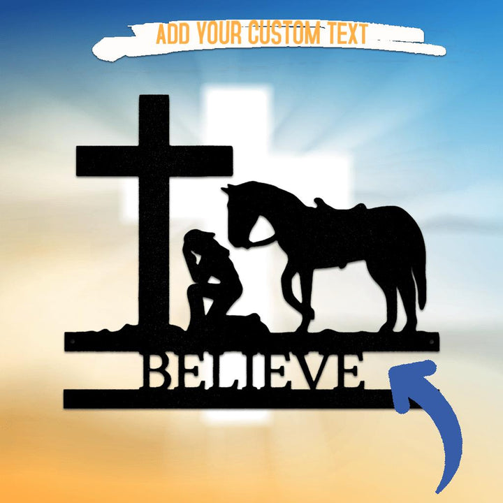 Black metal wall art: cowgirl kneeling by a cross and horse, with "BELIEVE" text.