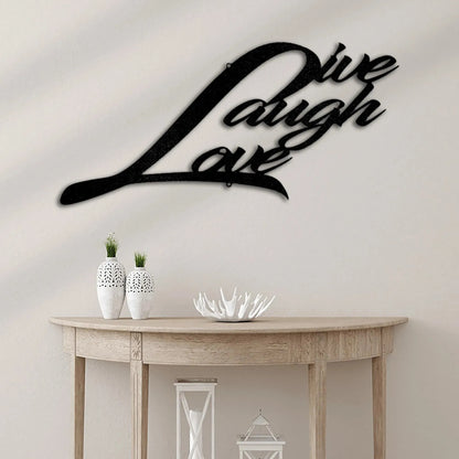 Black metal "Live Laugh Love" script wall art above a wooden console table with white vases.