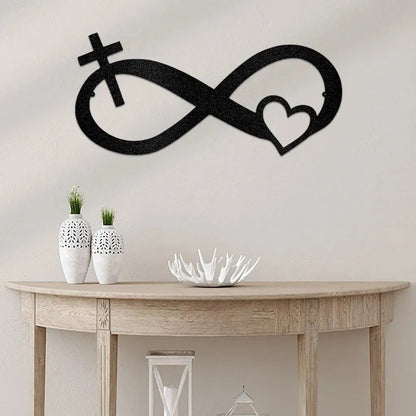 Black metal infinity symbol wall art with a cross and heart design, displayed above a console table.