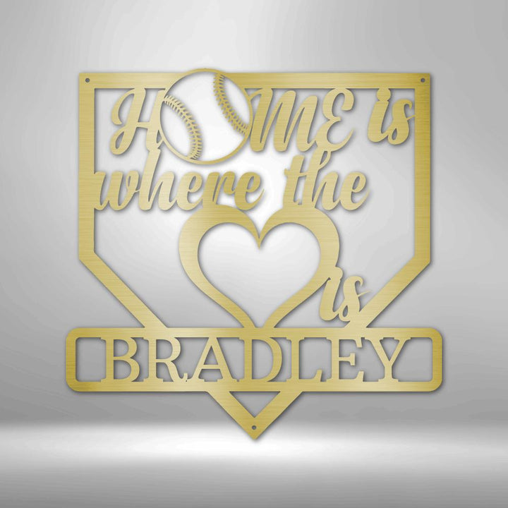 Gold metal baseball home plate sign with "Home is where the heart is" and "BRADLEY" text.