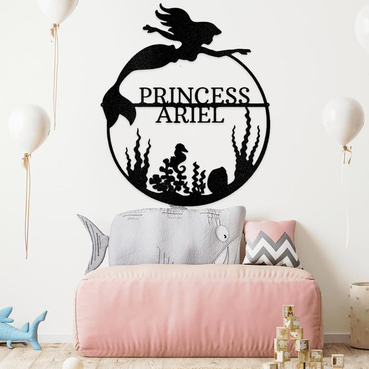 Black metal mermaid monogram wall art with "PRINCESS ARIEL" text, seahorse, and seaweed.