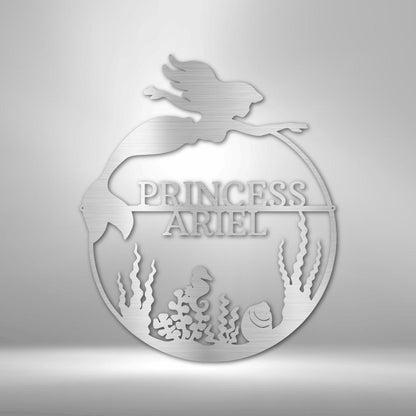 Silver metal mermaid monogram wall art with "PRINCESS ARIEL" and underwater scene.