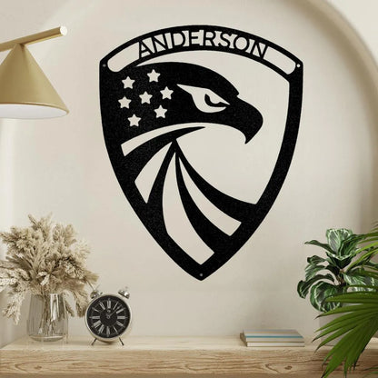 Black metal shield wall art with an eagle head, stars, stripes, and "ANDERSON" at the top.