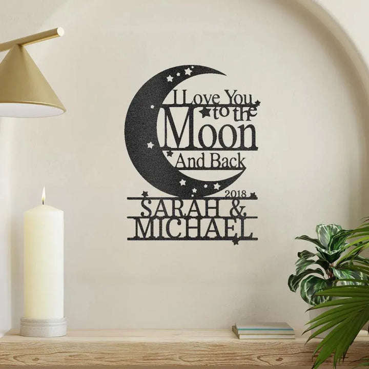 Black metal "I Love You To The Moon And Back" monogram wall art with "Sarah & Michael 2018" custom text.