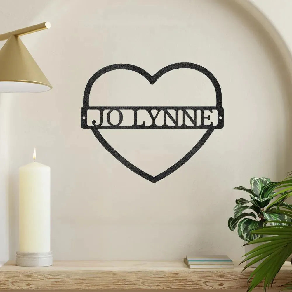 Black metal heart monogram wall art with "JO LYNNE" cutout, displayed on a light wall.