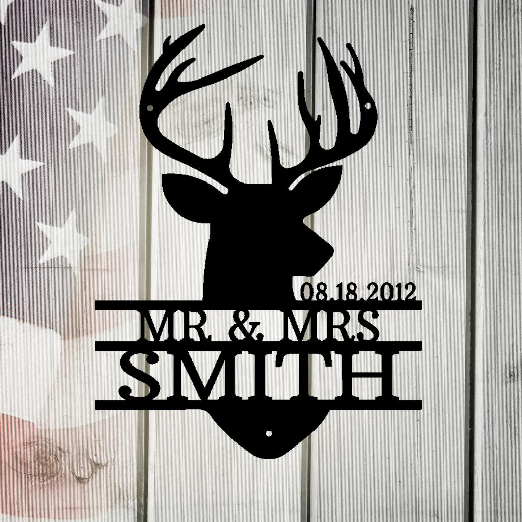 Black metal deer head monogram with "MR. & MRS. SMITH" and "08.18.2012" on a rustic American flag background.
