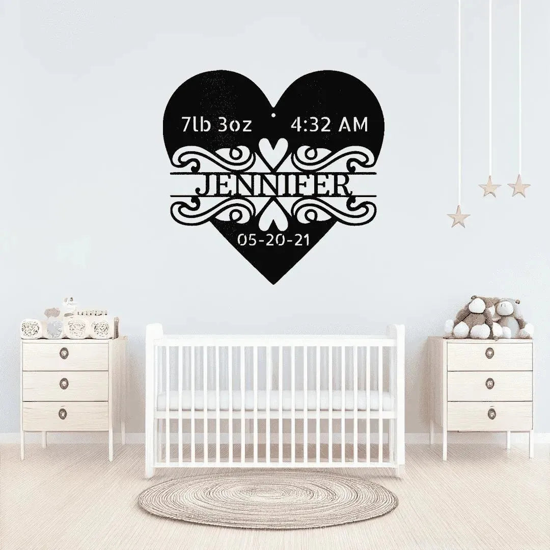 Black metal heart monogram with "Jennifer," birth weight, time, and date, above a white crib.
