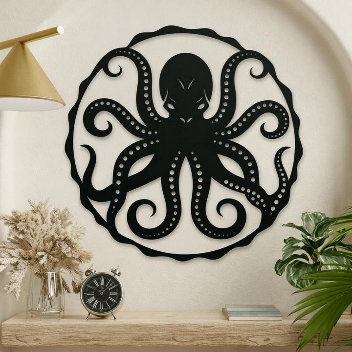 Black metal octopus wall art on a beige wall with a wooden shelf and decorative items.