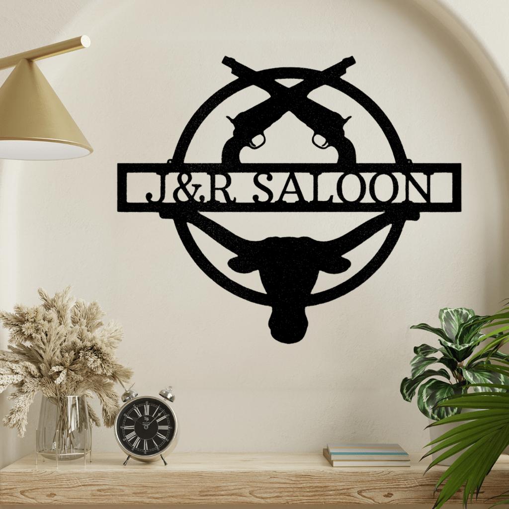 Black metal Old School Saloon Monogram wall art featuring crossed revolvers, a longhorn skull, and custom text.