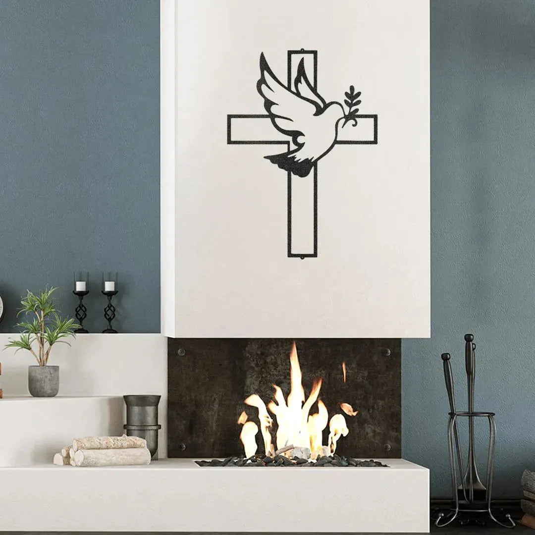 Black metal wall art featuring a dove with an olive branch on a cross, above a modern fireplace.