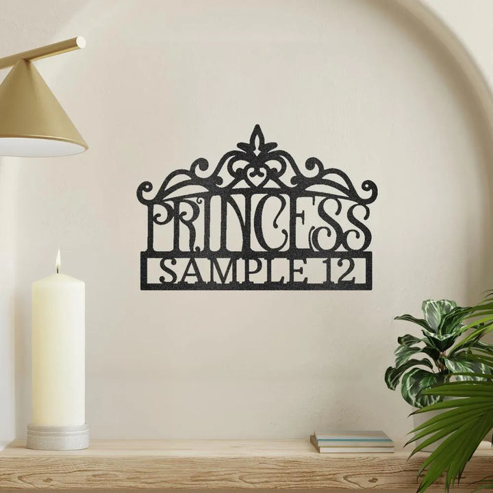 Black metal princess crown monogram wall art with "PRINCESS" and "[SAMPLE 12]" text.