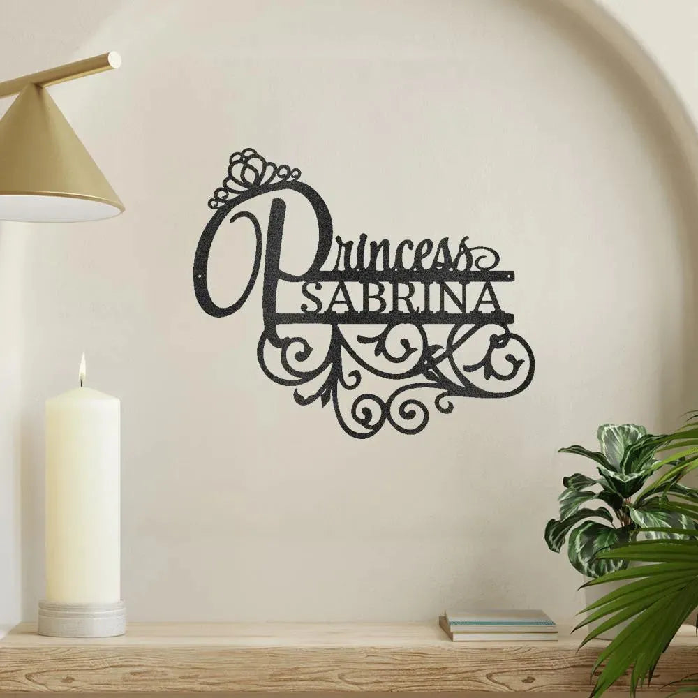 Black metal "Princess Sabrina" monogram wall art with crown and scroll details.