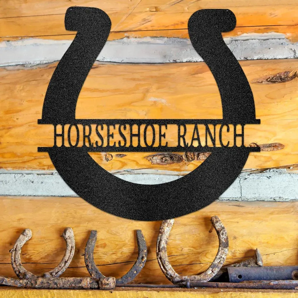 Black metal horseshoe monogram "HORSESHOE RANCH" sign on a rustic log wall.