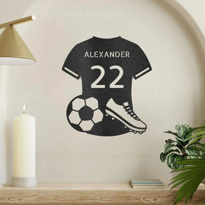 Black metal soccer jersey wall art with "ALEXANDER 22", a soccer ball, and cleat.