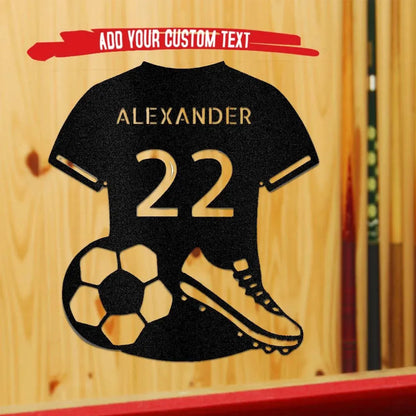 Black metal soccer jersey wall art with "ALEXANDER 22", a soccer ball, and cleat.