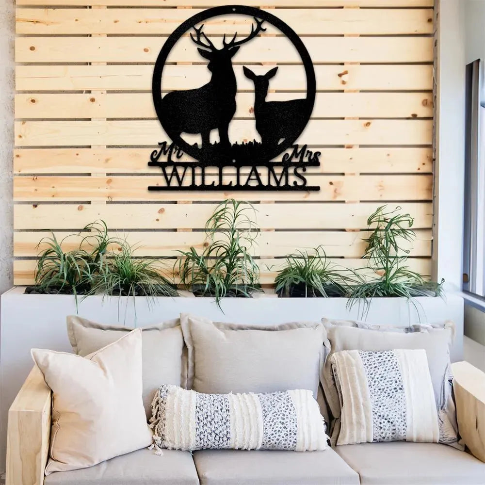 Black metal stag and doe monogram with "Mr & Mrs Williams" text, mounted on a wooden slat wall above a couch.