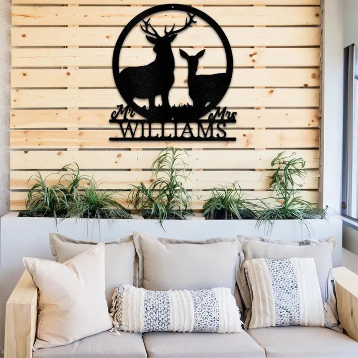 Black metal stag and doe monogram with "Mr & Mrs Williams" text, mounted on a wooden slat wall above a couch.