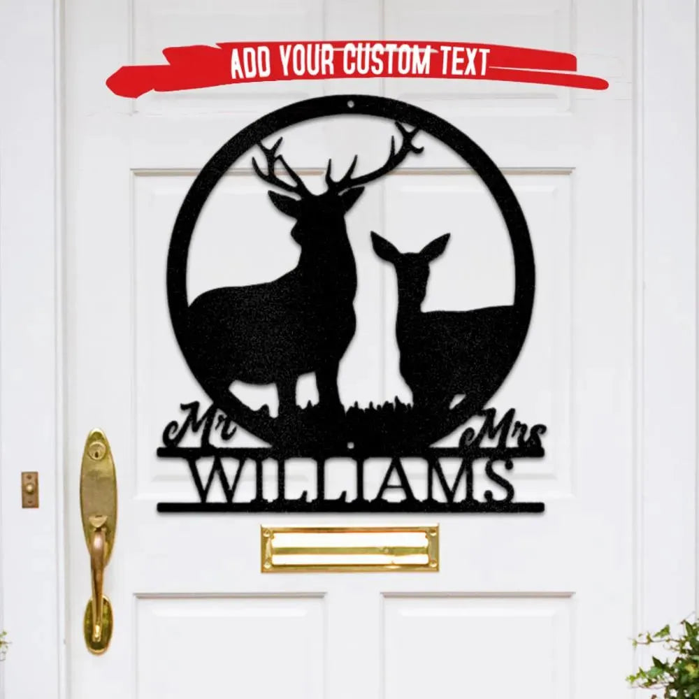 Black metal Stag and Doe monogram with "Mr. & Mrs. Williams" custom text, hanging on a white door.