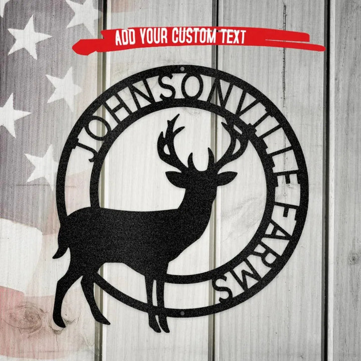 Black metal Stag Monogram wall art with "JOHNSONVILLE FARMS" text, on a rustic wood and flag background.