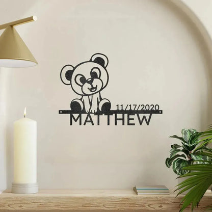 Black metal Teddy Monogram wall art with "Matthew" and "11/17/2020" on a light wall.