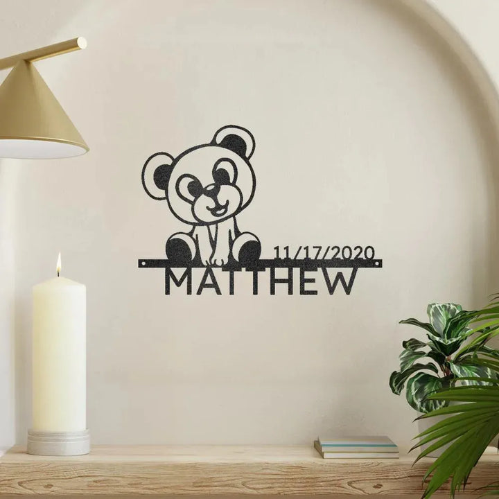 Black metal Teddy Monogram wall art with "Matthew" and "11/17/2020" on a light wall.