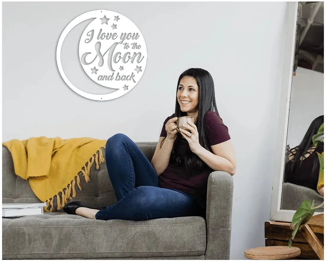 White "I love you to the Moon and back" metal wall art with stars and crescent moon design.