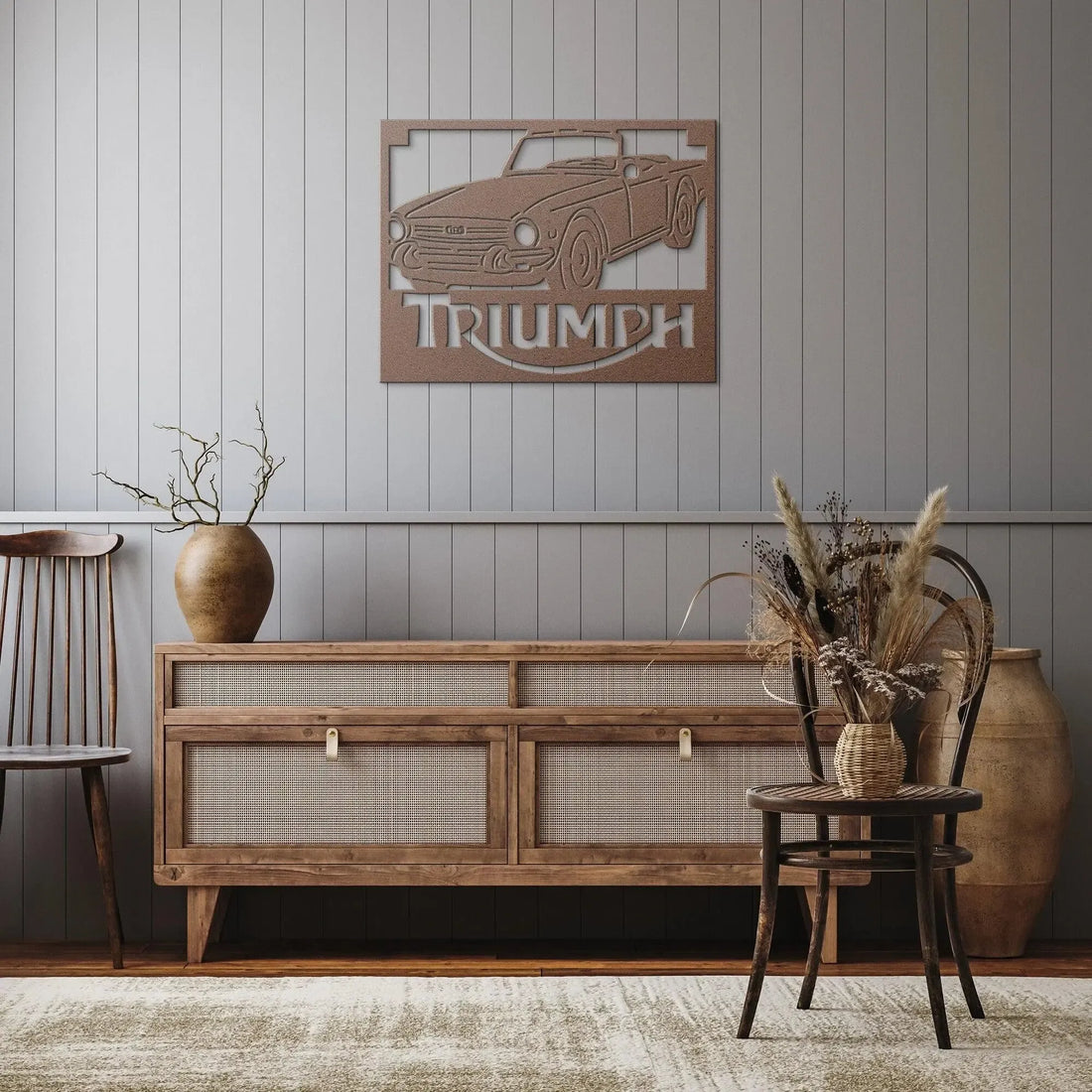 Wooden sideboard with decorative car emblem and 'Triumph' text on a wall.
