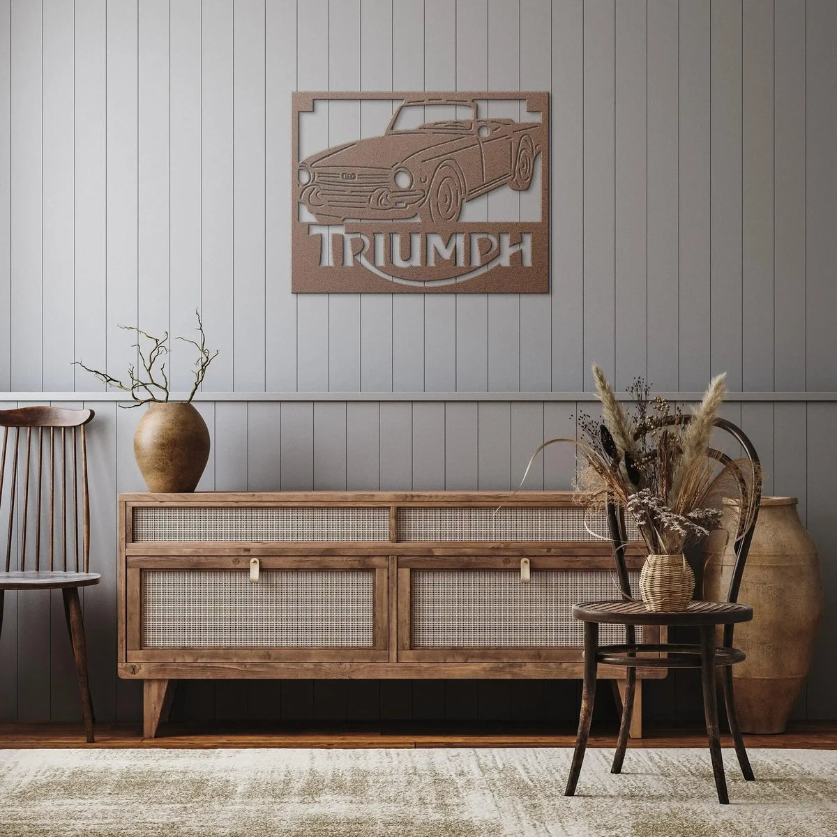 Wooden sideboard with decorative car emblem and 'Triumph' text on a wall.