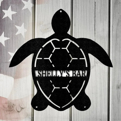Black metal turtle wall art with "SHELLY'S BAR" cutout, on a distressed American flag wood background.