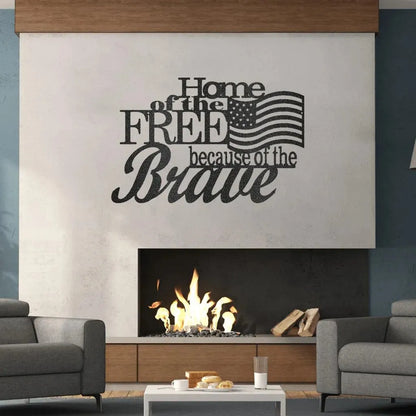 Black metal wall art with "Home of the Free because of the Brave" and an American flag design above a fireplace.